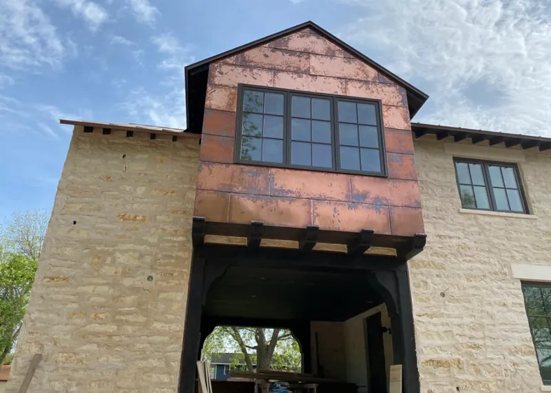 Copper metal panel facade on a stone building for Metal Roof Coating in Fort Lewis